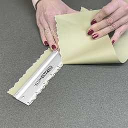 Alumicolor AlumiCrafter Tearing Ruler - 12", paper being torn with deckled edge