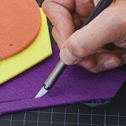 Slice Ceramic Craft Knife - Closeup of knife slicing through felt material
