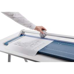 Dahle Professional Rotary Trimmer - 28" Cutting Length, hand moving the rotary blade across a print