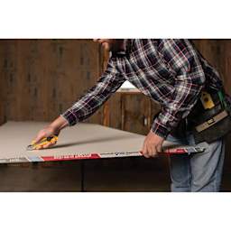 Olfa Ratchet-Lock Utility Knife being used to cut drywall