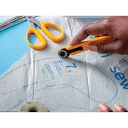 Olfa Quick-Change Rotary Cutter, in hand cutting template