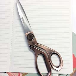 Westcott Vintage Copper Finish Scissors - 8" closed laying on notebook