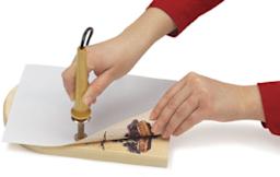 Transfer Tool - Design being transferred to wooden board with Tool