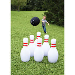 Inflatable Bowling Game - Child throwing inflatable ball at pins
