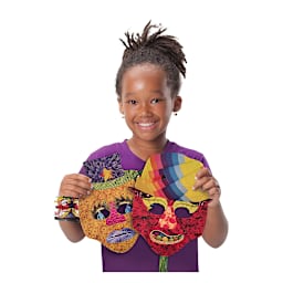 Roylco Mish Mash Mask Kit - Child holding two Completed Masks
