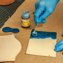 Realeather Wool Daubers - one dauber in hand, dying a piece of leather
