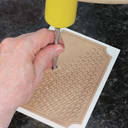 Realeather Mallets - Artist using Mallet to punch design in leather
