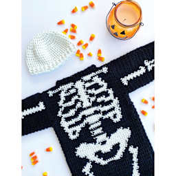 Lion Brand DIY Glow Yarn - laid beanie and skeleton-themed sweater