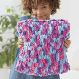 Lion Brand Off The Hook Yarn (Person holding pillow)