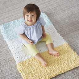 Lion Brand Off The Hook Yarn (Child sitting on blanket)