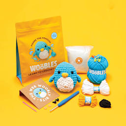 The Woobles Beginner Crochet Amigurumi Kits - Penguin, contents and finished design laid out