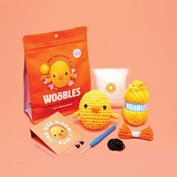 The Woobles Beginner Crochet Amigurumi Kit - Chick, contents and finished design laid out