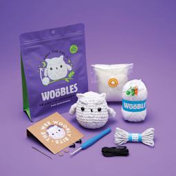 The Woobles Beginner Crochet Amigurumi Kit - Owl, contents and finished design laid out
