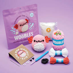 The Woobles Beginner Crochet Amigurumi Kit - Axolotl front of packaging, finished, and contents