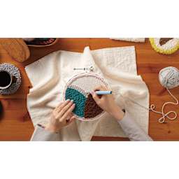 Clover Punch Needle Hoop, needle in hand working on project 