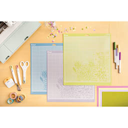Cricut Adhesive Cutting Mats - Top view of All 3 Cutting Mats on Desk with various art supplies