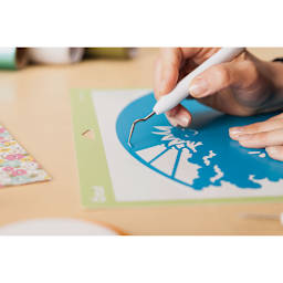 Cricut Weeding Tool Kit - Closeup of artist cutting vinyl out of picture with Angle Tip Weeder
