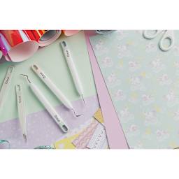 Cricut 12" Essential Tool Set - Component tools in Set shown with decorative papers