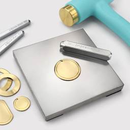 ImpressArt Steel Blocks - Metal blank on steel block with stamp and hammer