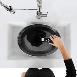 Rit Back to Black Dye Kit - Overhead view of dye being poured into sink