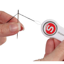 Singer Machine and Hand Needle Threaders, in use pulling thread through a needle