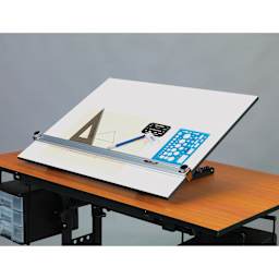 Pro-Draft Deluxe Parallel Straightedge Drawing Board, tilted on a table with drawing tools on top
