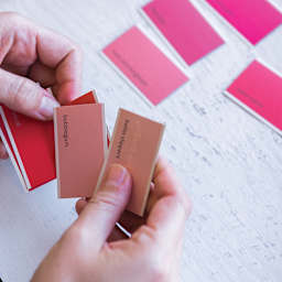 Paint Chip Poetry Game - Hands holding paint chips from game