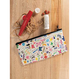 Blue Q Zipper Pencil Pouch - Doodle Party, 8-1/2" x 4-1/4", on table with art materials (not included)