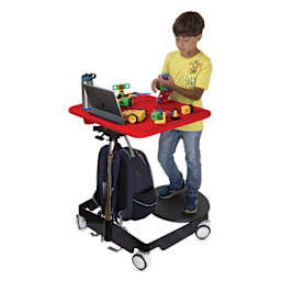 A child standing at a Kore Design Kids Sit-Stand Mobile Student Desk.