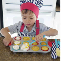 Handstand Kitchen Mini Cupcake Set, child decorating cupcakes inside of baking tray.