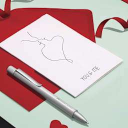Faber-Castell Hexo Ballpoint Pen - Matte Silver, next to envelope and card