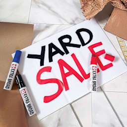 Sakura Extra Broad Permanent Ink Markers, laid on top of signage made with markers