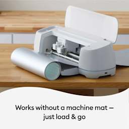 Cricut Removable Smart Vinyl - Metallic Silver, roll being loaded in machine (machine not included)