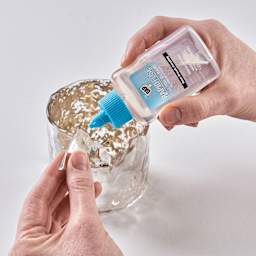 DAP RapidFuse Ultra Clear All Purpose Adhesive - 1.67 oz Bottle being applied to glass