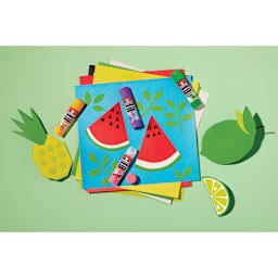 Elmer’s Scented Glue Sticks - Fruity, Pkg of 4, laid out on top of colored paper