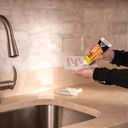 DAP Heavy Duty Instant Grab Adhesive - 3 oz Tube being applied to tile