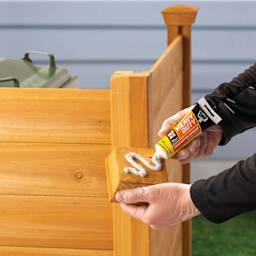 DAP Heavy Duty Instant Grab Adhesive - 3 oz Tube being applied to wooden post top
