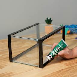 DAP All Purpose Adhesive Silicone Sealant - 2.8 oz Tube being applied to aquarium tank