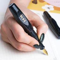 Benu Pixie Fountain Pen - Smoky Black, pen in hand (image may show a different size nib)