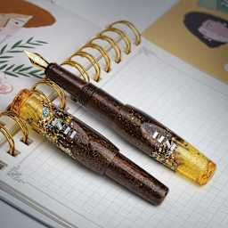 Benu Pixie Fountain Pen - Honey Bronze, two pens laid out (image may show a different size nib)
