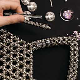 Caran d'Ache Ecridor Germanier Ballpoint Pen Special Edition, held next to luxury crafts