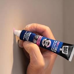 DAP DryDex Nail Hole Filler - 1 oz Tube being applied to wall