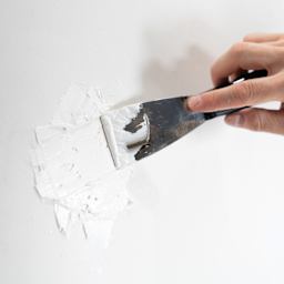 DAP Patching Plaster - 32 oz Tub being smoothed by putty knife