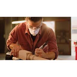 Dremel Wood Accessory Kit - Man using tool and accessory to touch up post