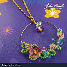 A variety of John Bead Crystal Lane DIY Glass Garden Beads used to create a necklace pendant.