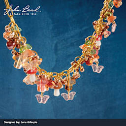 A variety of John Bead Crystal Lane DIY Glass Garden Beads used to create a necklace.