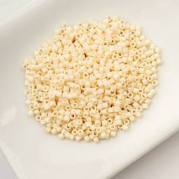 John Bead Cylin 11/0 Cylindrical Seed Beads - Dark Cream sitting in dish