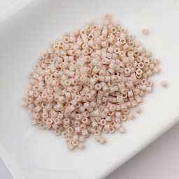 John Bead Cylin 11/0 Matte Macaron Cylindrical Seed Beads - Oat Milk sitting in dish