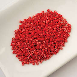John Bead Cylin 11/0 Cylindrical Seed Beads - Red Opaque sitting in dish