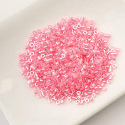 John Bead Cylin 11/0 Ceylon Cylindrical Seed Beads - Dark Crystal Pink Lined, 25g sitting in dish